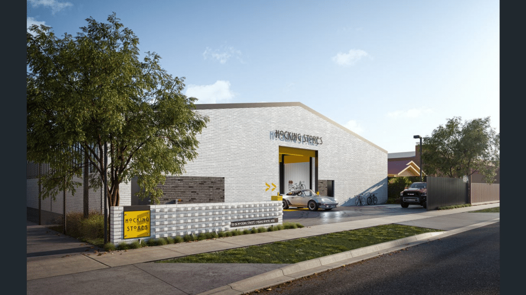 Exterior view of Hocking Stores mini warehouse development in Coburg North, Melbourne, with roller door and street signage